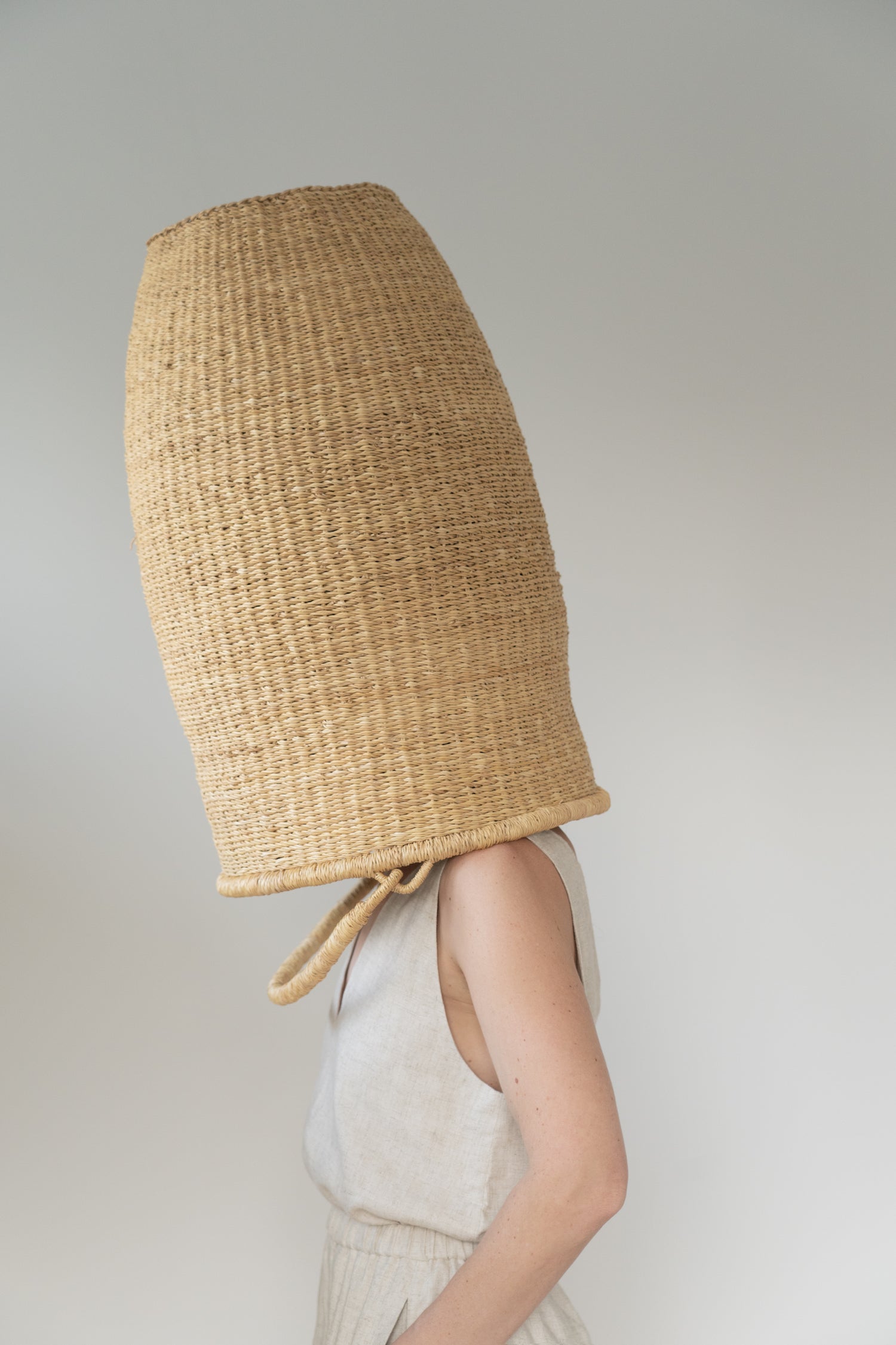 Extra large basket over a woman's head.