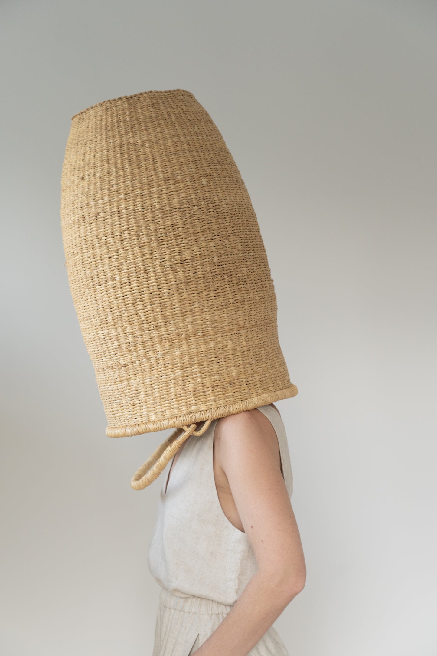 Extra large basket over a woman's head.