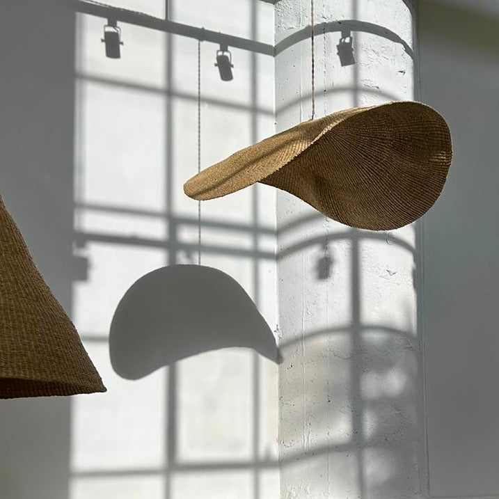 Our Fawn pendant lights are handwoven from natural colored elephant grass in northern Ghana. Their wide and floating shape is striking in any living space, especially over a dining table or kitchen island.
