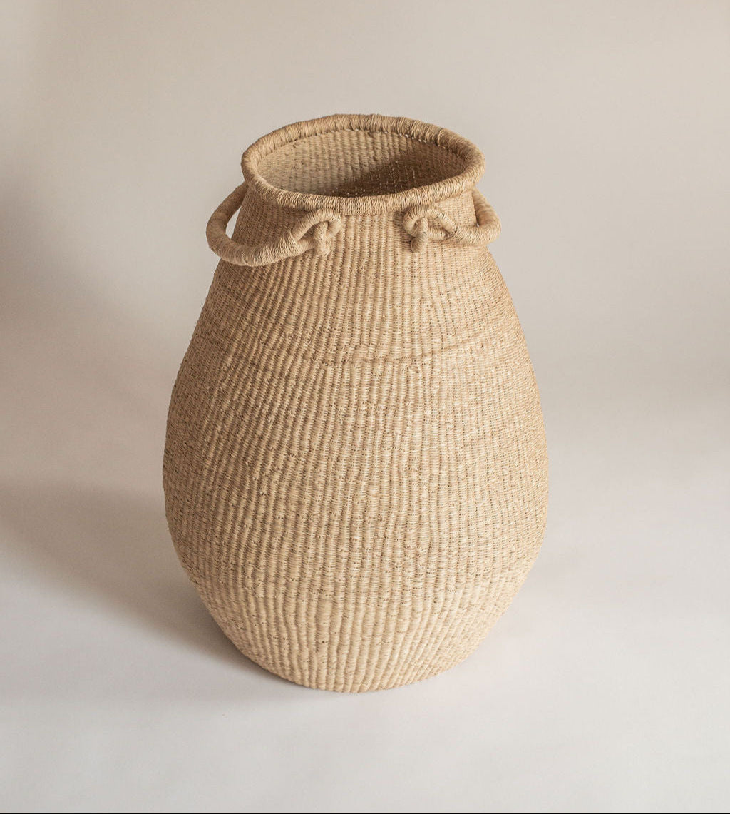Large garlic shaped gourd basket, handwoven with two handles. Made in Ghana from local sustainable grass.