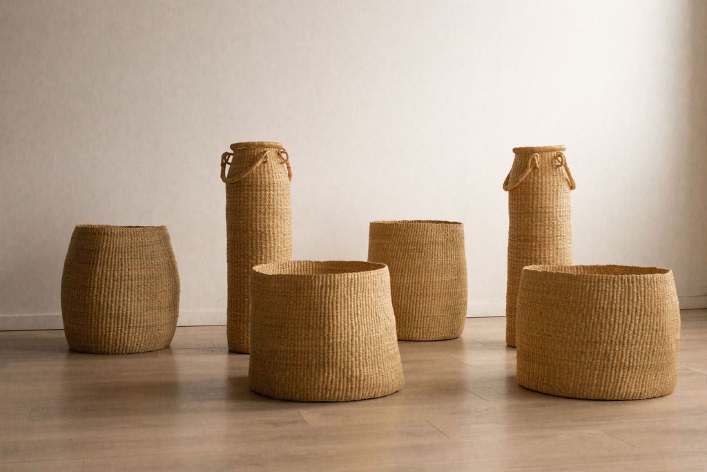 Many hand woven, natural storage baskets.