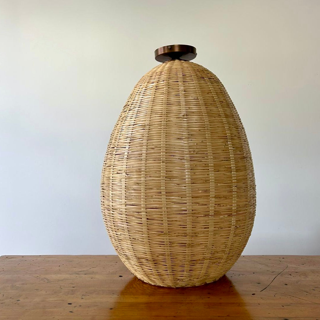 The Brava Light is a large, hand-woven, egg-shaped, ceiling-mounted pendant light, made from a bamboo-like river reed by skilled craftspeople in Oaxaca, Mexico. A perfect light for kitchens, hallways, and living rooms.