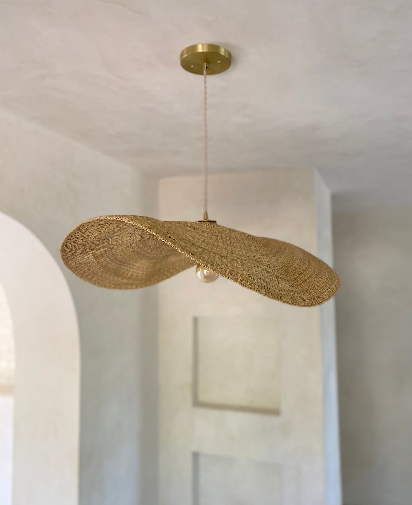 Our Fawn pendant lights are handwoven from natural colored elephant grass in northern Ghana. Their wide and floating shape is striking in any living space, especially over a dining table or kitchen island.
