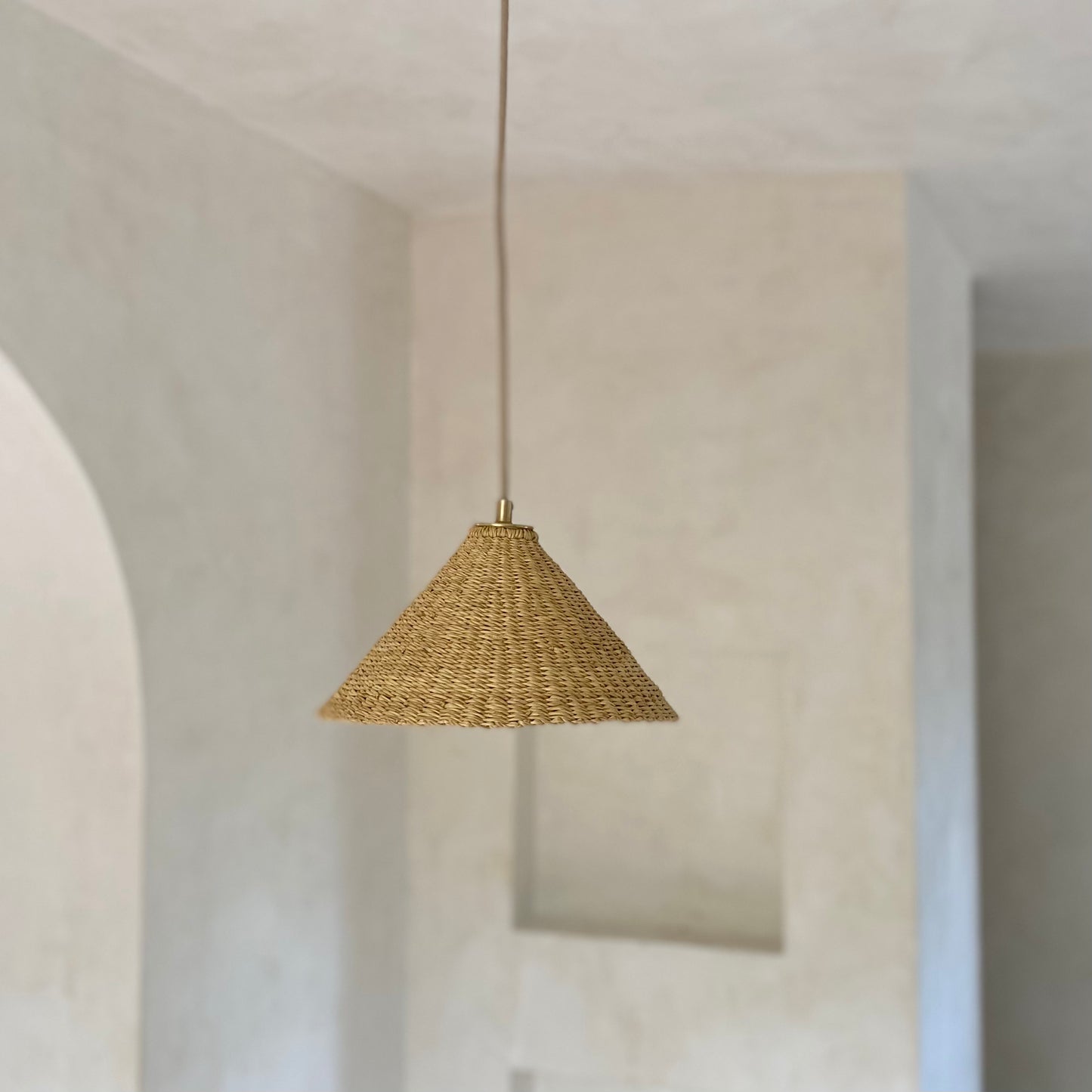 Our Bonnet pendant lights are a conical shape, handwoven from natural colored, indigenous elephant grass by members of a women’s organization in northern Ghana. A perfect-sized pendant for any room or living space.