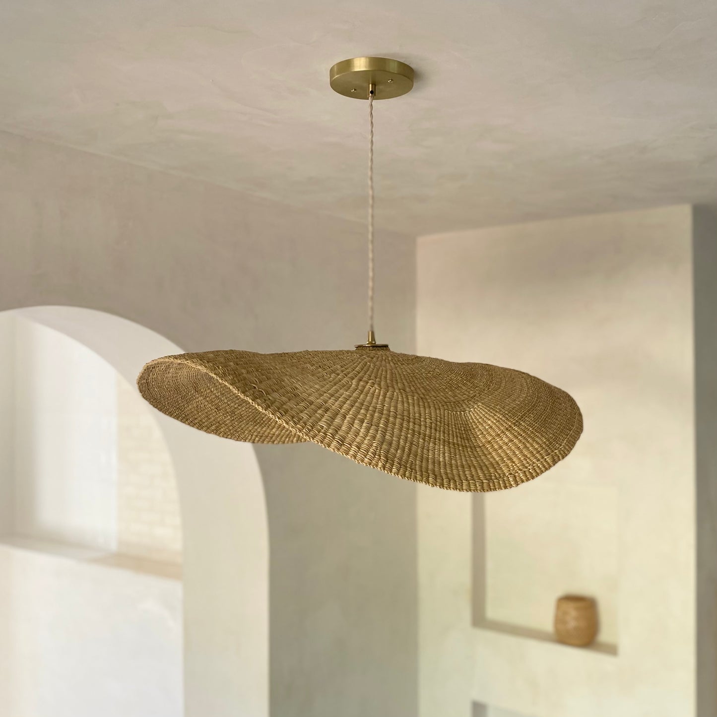 Our Fawn pendant lights are handwoven from natural colored elephant grass in northern Ghana. Their wide and floating shape is striking in any living space, especially over a dining table or kitchen island.