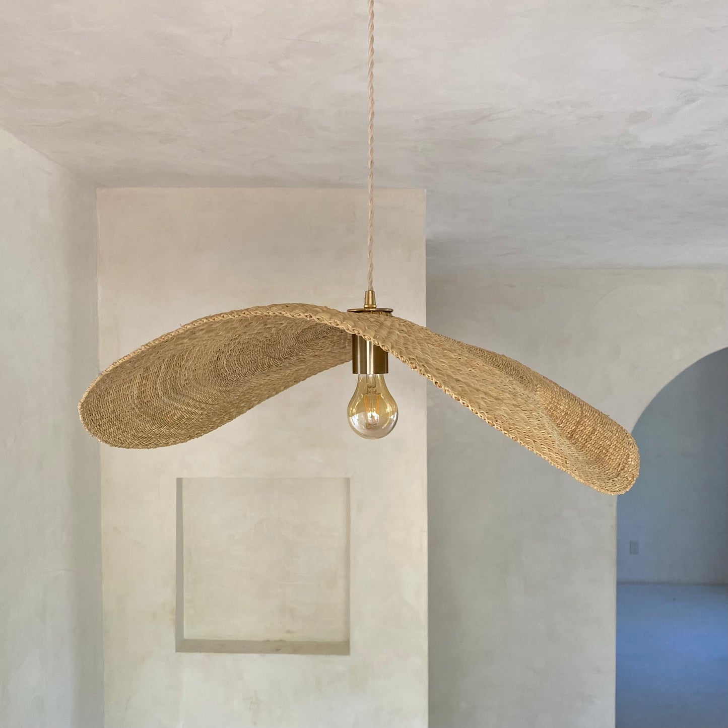 Our Fawn pendant lights are handwoven from natural colored elephant grass in northern Ghana. Their wide and floating shape is striking in any living space, especially over a dining table or kitchen island.
