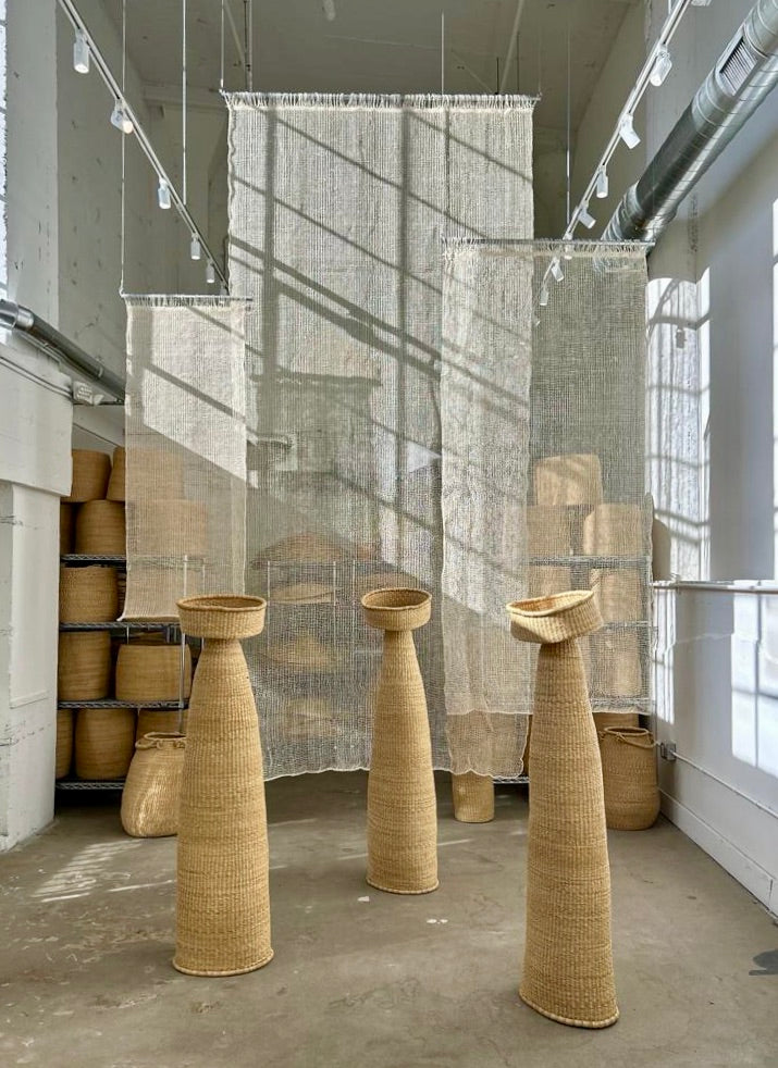 The Cortina Maguey is a handwoven sheer textile hanging, made in Oaxaca, Mexico. These natural colored curtains make beautiful room dividers, window coverings or wall hangings. Shown here with woven sculptures.