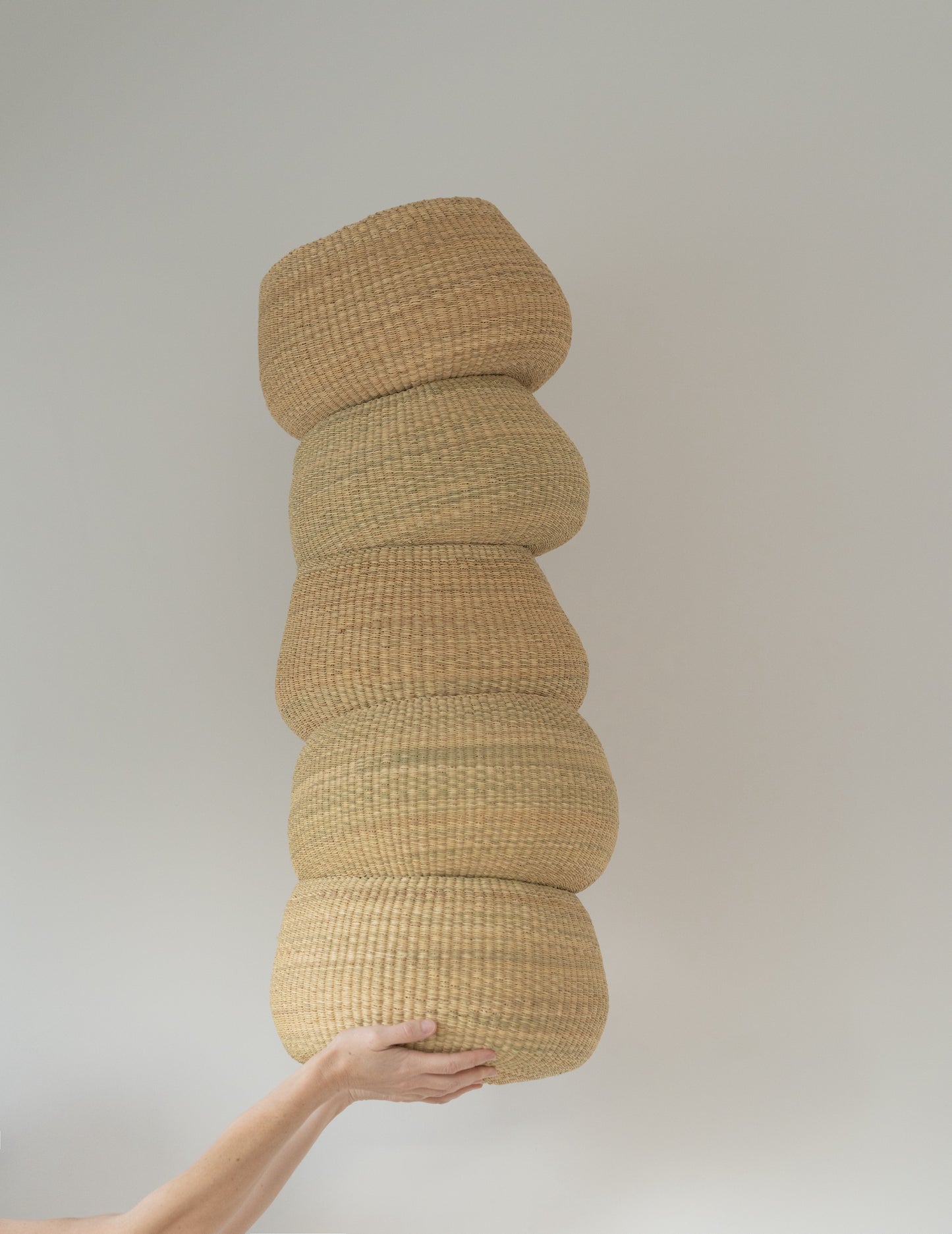 Small handwoven baskets made from natural colored elephant grass, from northern Ghana.