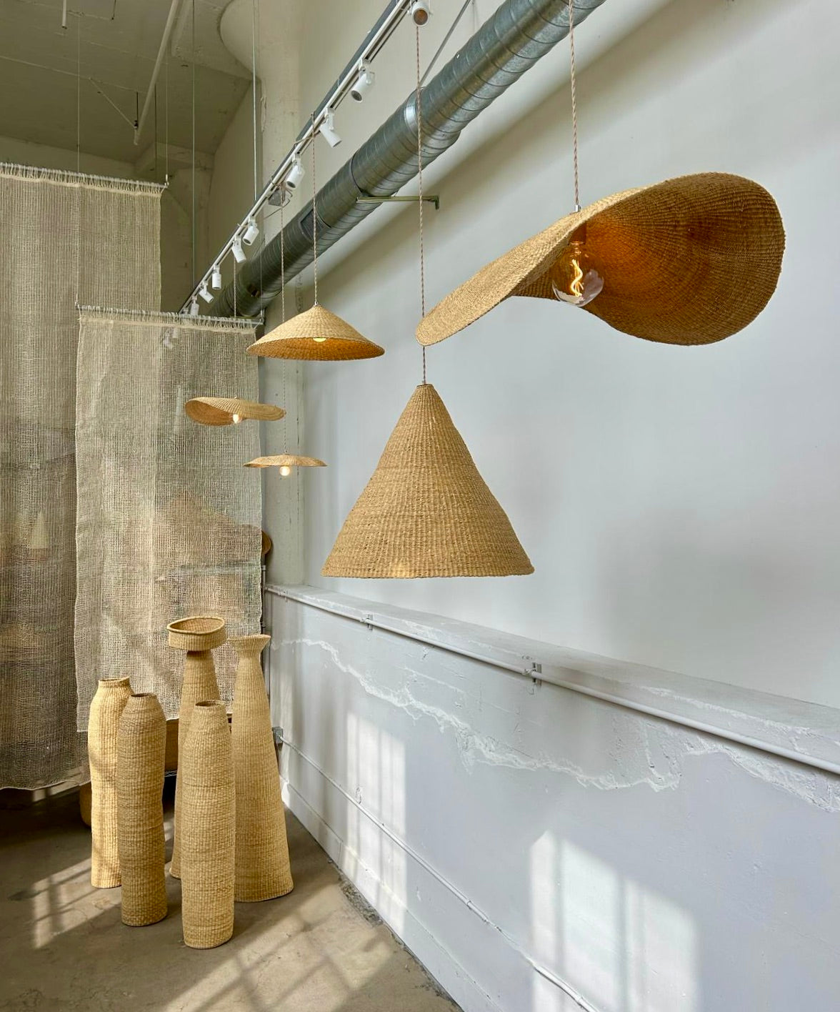 Our Fawn pendant lights are handwoven from natural colored elephant grass in northern Ghana. Their wide and floating shape is striking in any living space, especially over a dining table or kitchen island.