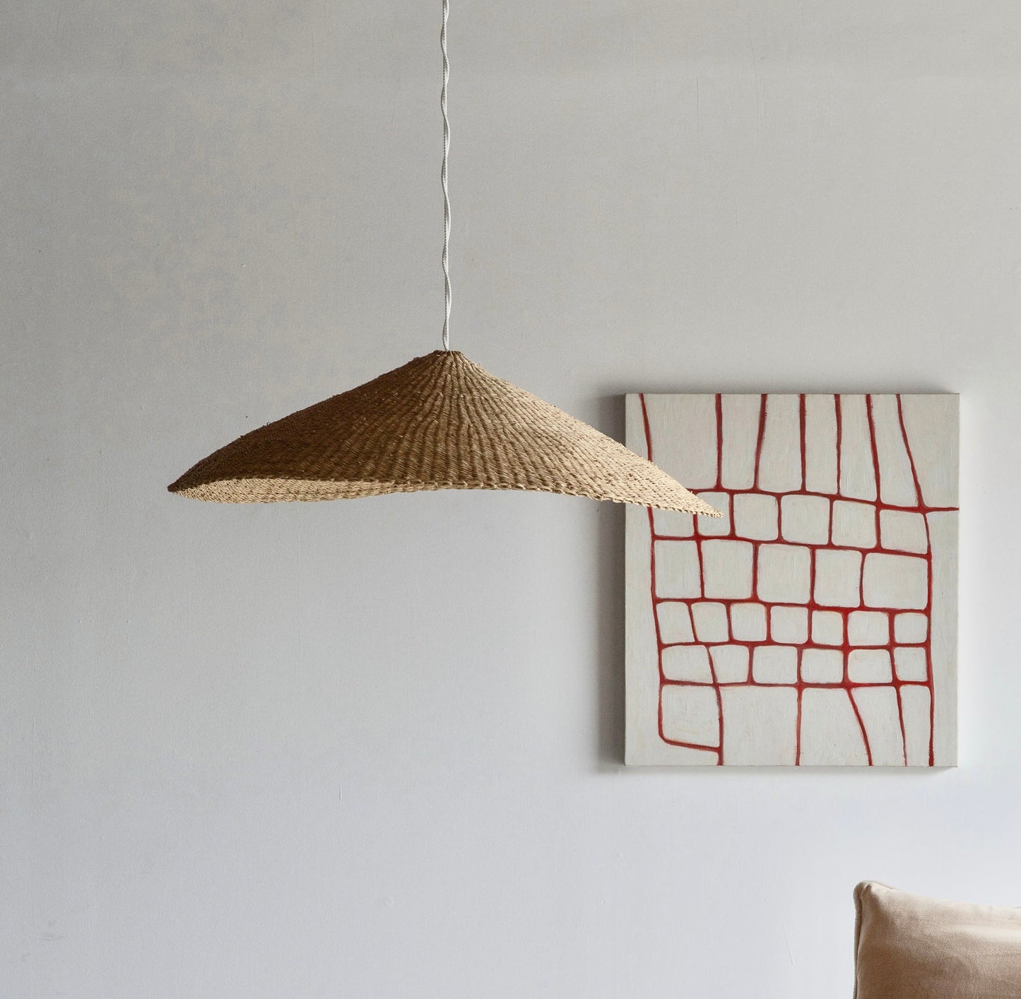 These Sunhat light shades are handcrafted from sustainable elephant grass in Ghana, and woven into a shallow cone shape.