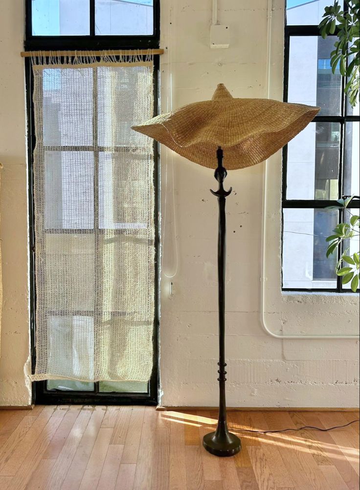 Woven light shade on floor lamp, handwoven from sustainable elephant grass in Ghana.