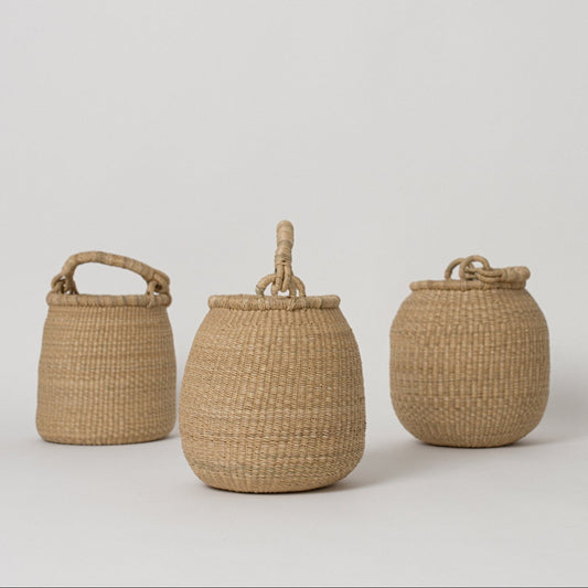 Small handwoven baskets with handles, made from natural colored elephant grass, from northern Ghana.