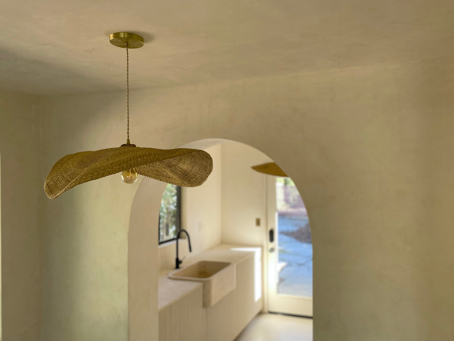 Our Fawn pendant lights are handwoven from natural colored elephant grass in northern Ghana. Their wide and floating shape is striking in any living space, especially over a dining table or kitchen island.