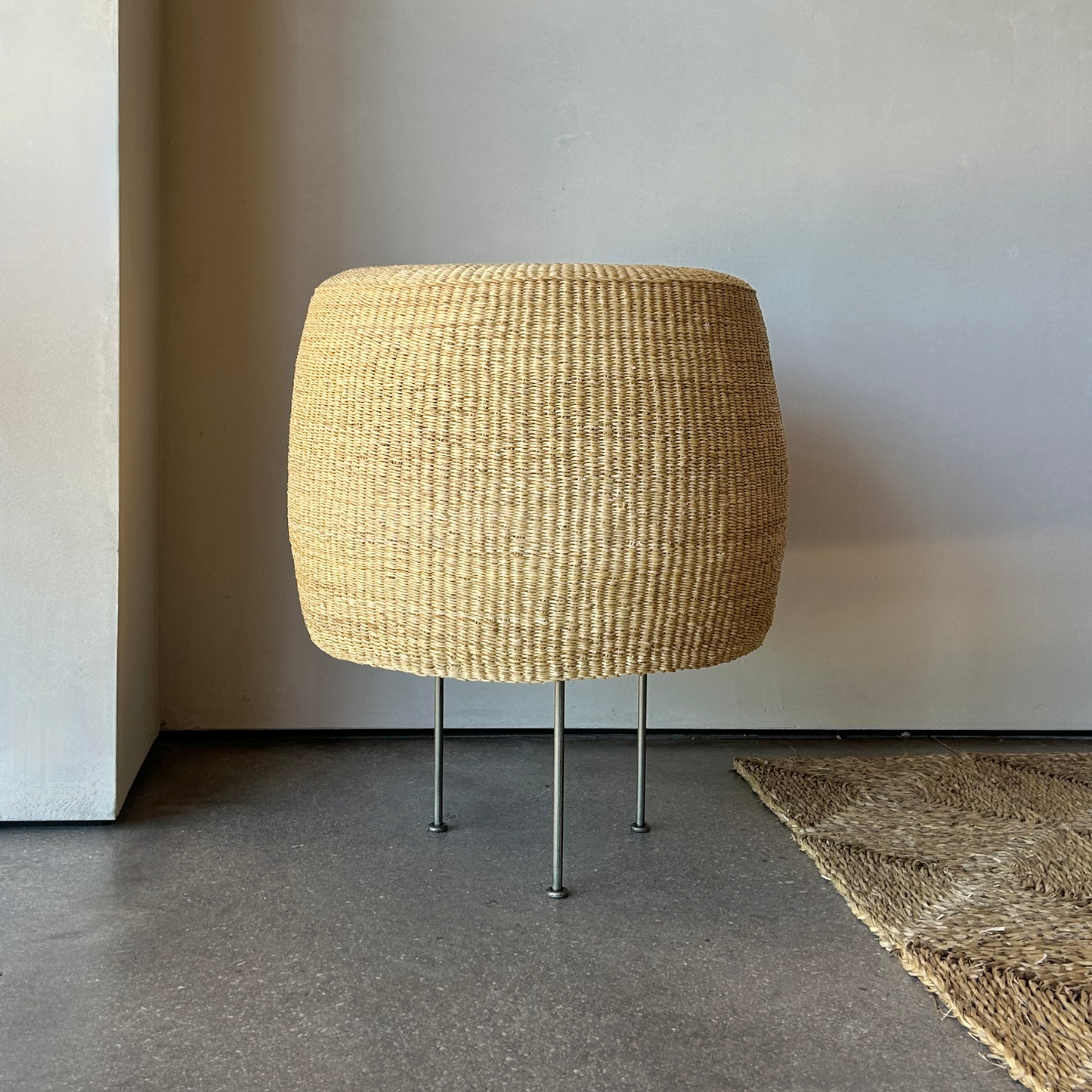 Woven floor lamp with steel tripod base 