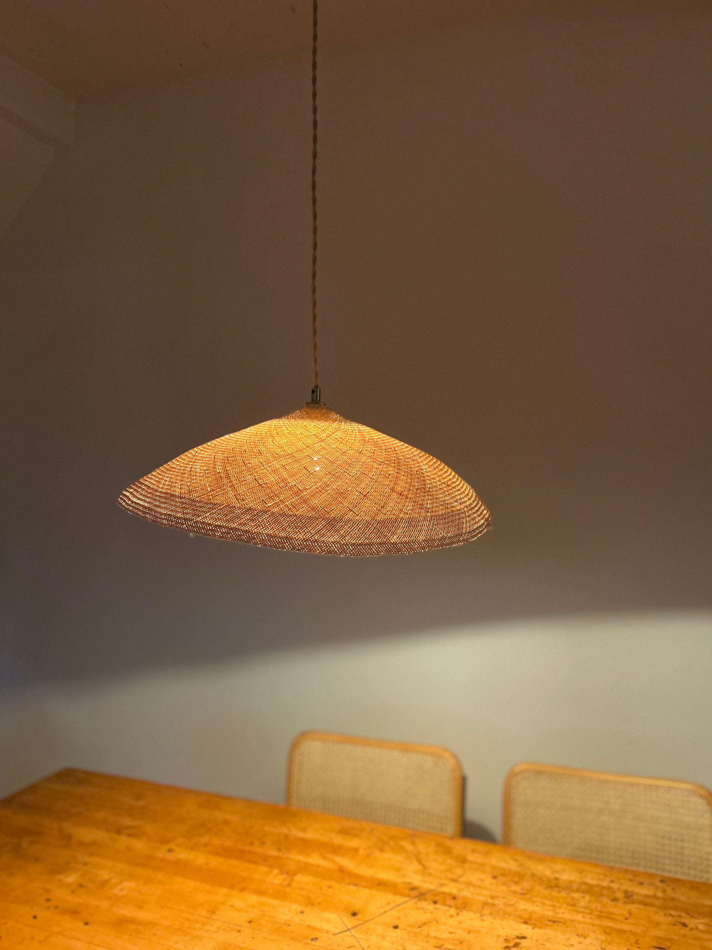 Palma Pendant Light, natural palm weave glowing softly, local plant material