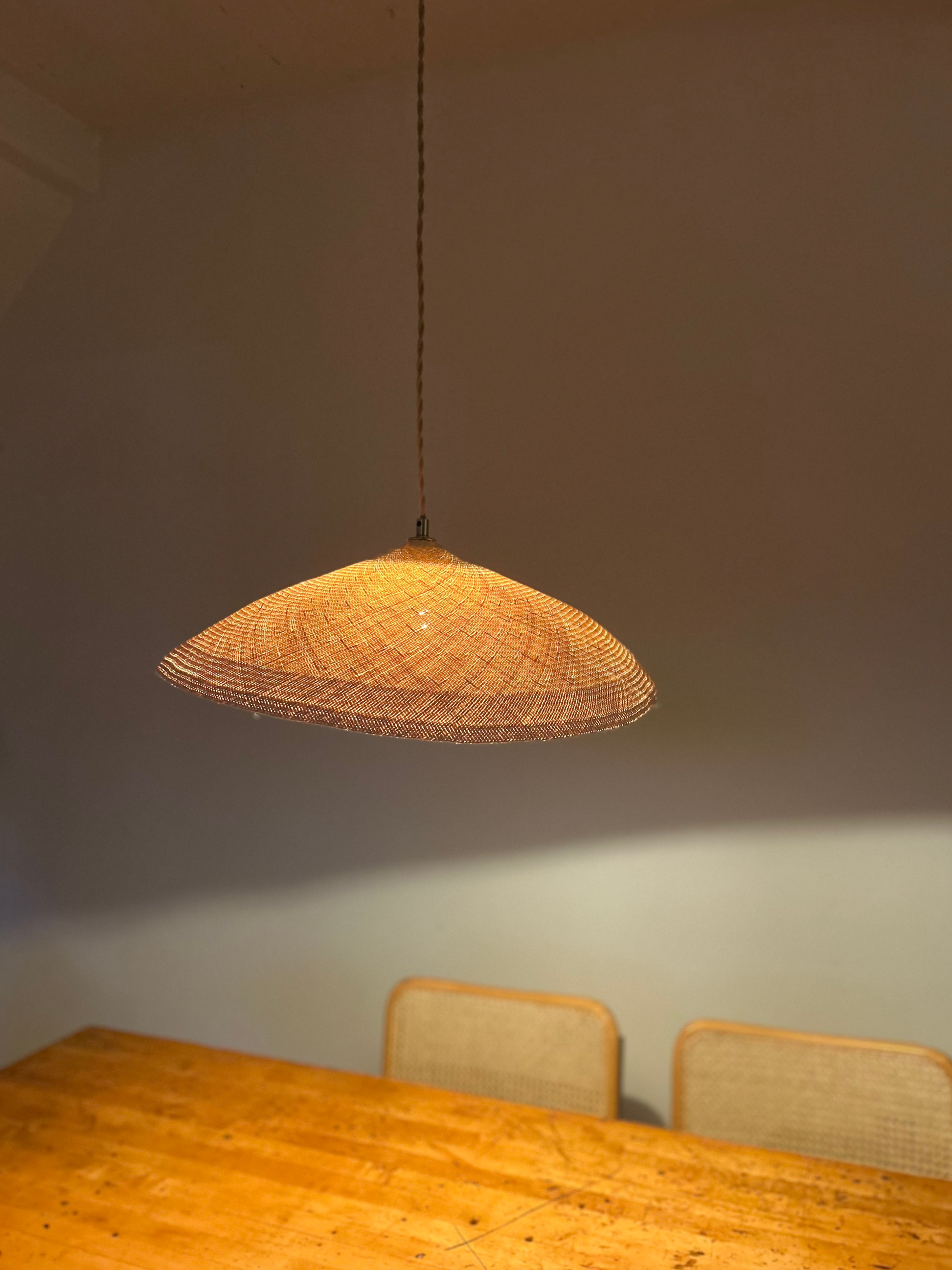 Palma Pendant Light, natural palm weave glowing softly, local plant material