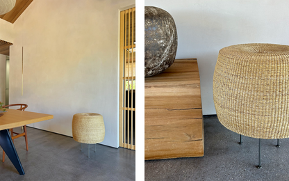 Woven floor lamp with steel tripod base in a natural modern interior