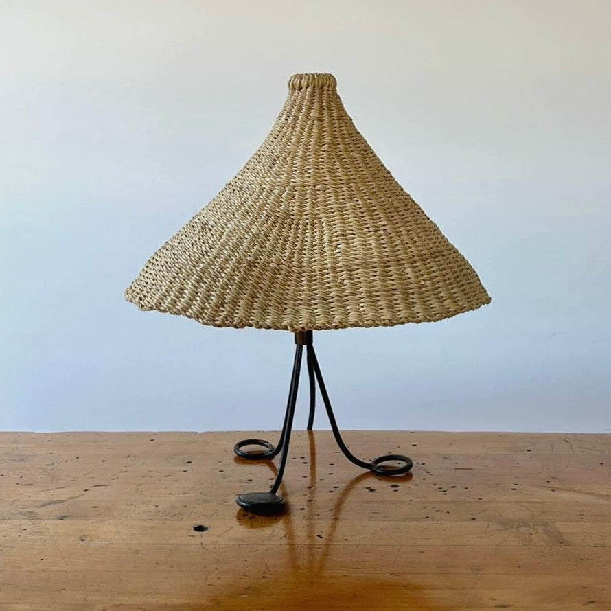 Modernist, iron table lamp from France circa 1950s. Paired with a coned shaped hand woven lamp shade.