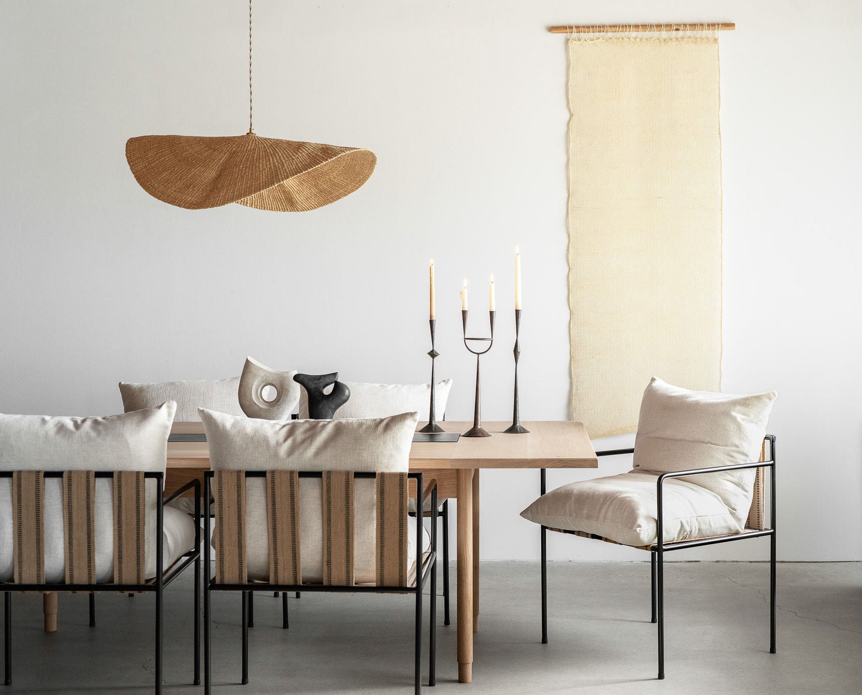 Our Cortina Puerta is a sheer handwoven textile hanging, 76” high by 27” wide. Shown here against a wall in a dining room. These natural colored curtains make beautiful room dividers, window coverings or wall hangings.