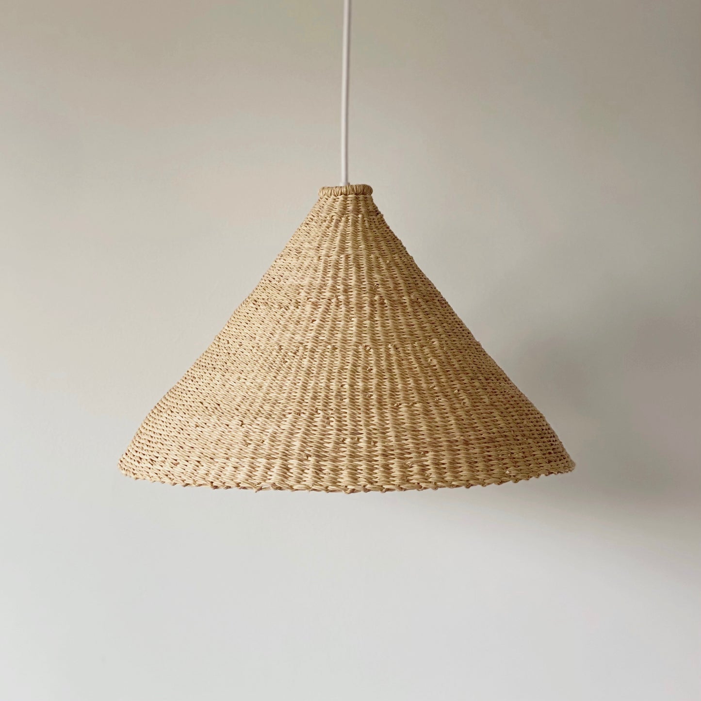 Our Bonnet light shades are handwoven from sustainable elephant grass in Ghana. These natural colored, conical shaped shades are perfect for bedrooms, hallways, kitchens and living spaces.