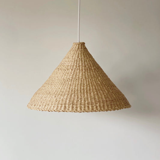Our Bonnet light shades are handwoven from sustainable elephant grass in Ghana. These natural colored, conical shaped shades are perfect for bedrooms, hallways, kitchens and living spaces.