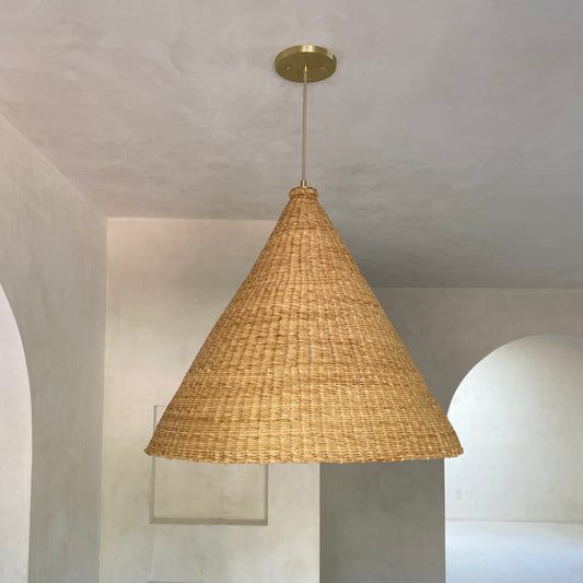 Our Bonnet pendant lights are a conical shape, handwoven from natural colored, indigenous elephant grass by members of a women’s organization in northern Ghana. A perfect-sized pendant for any room or living space.