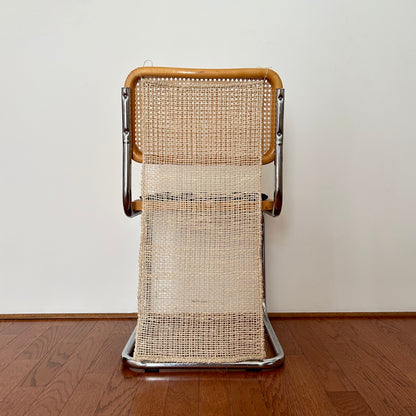 The Cortina Silla is a natural colored, handwoven textile hanging. It's made in Oaxaca, Mexico, from the leftover maguey leaves from mezcal production. Shown hanging from the back of a chair, as it's designed to do, by ties at the top corners.
