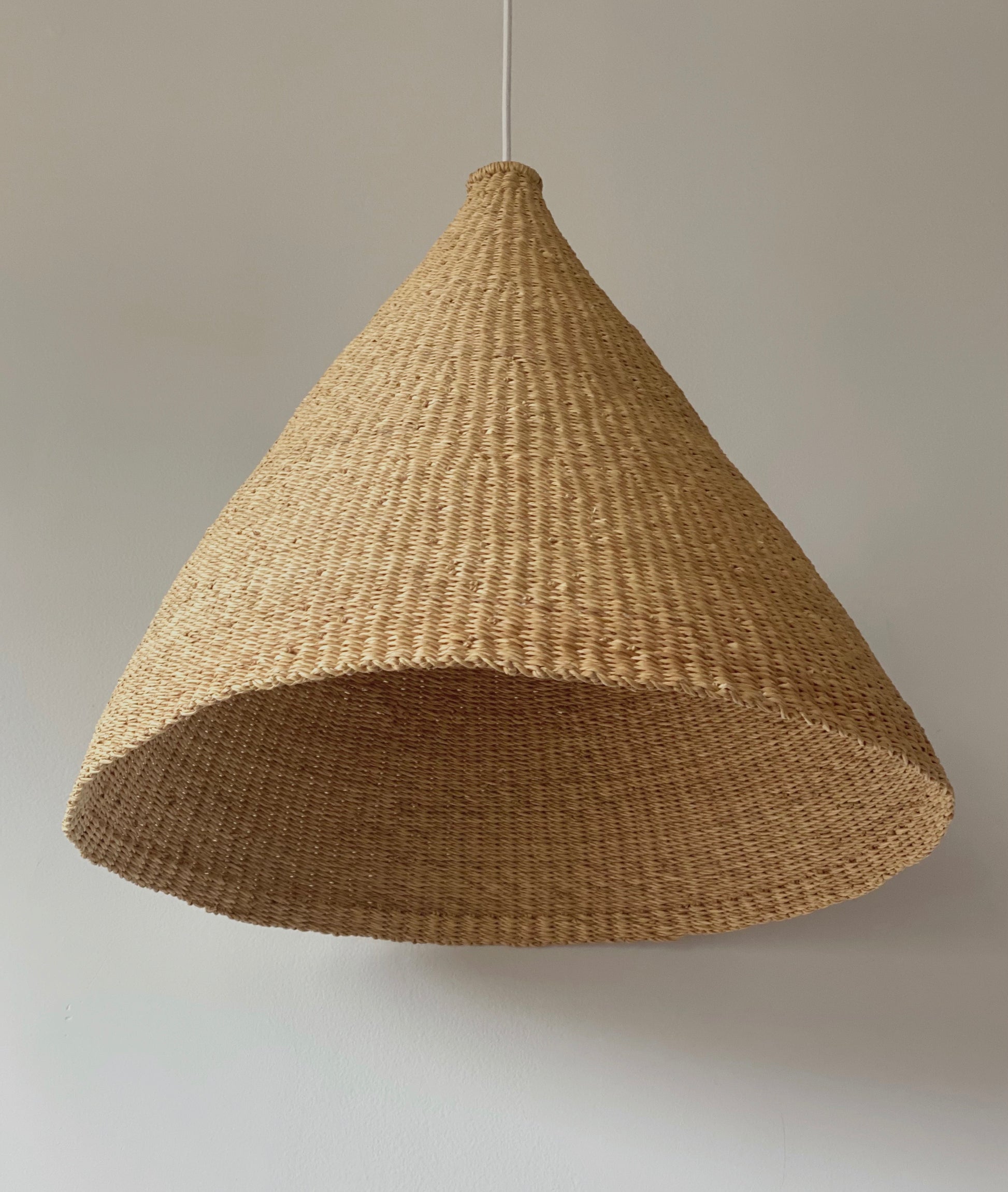 Bonnet light shade, handwoven from sustainable elephant grass in Ghana. Natural colored, conical shaped shades - perfect for bedrooms, hallways, kitchens and living spaces.