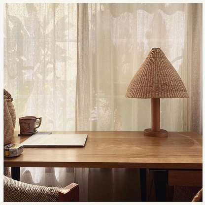 Table lamp with hand woven natural material light shade.