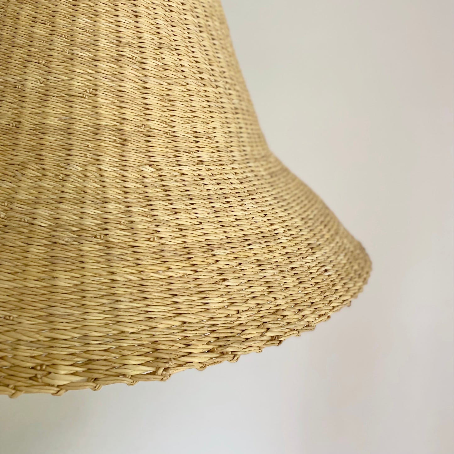 Close of textured hand woven natural lamp shade.